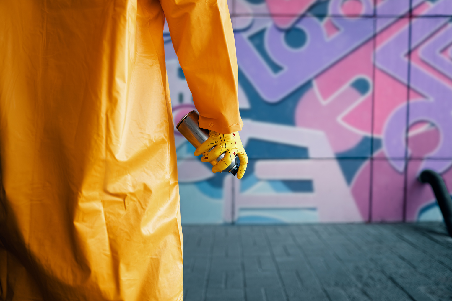 Man in Raincoat and Spray Can Copy Space